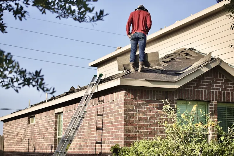Professional roofer working on a residential roof in Saint Anna